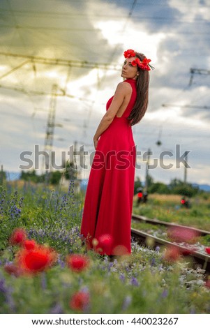 young girl with a beautiful dress on railroad tracks