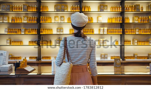 Young girl in a\
beauty store in Paris,\
France