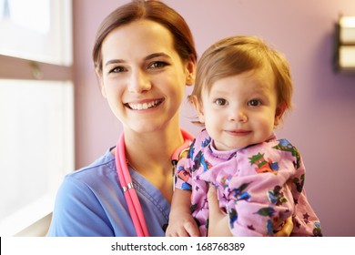 Young Girl Being Held By Female Pediatric Nurse