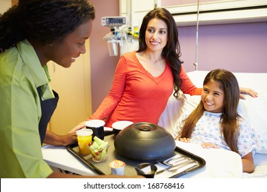 Young Girl Being Served Lunch In Hospital Bed - Powered by Shutterstock