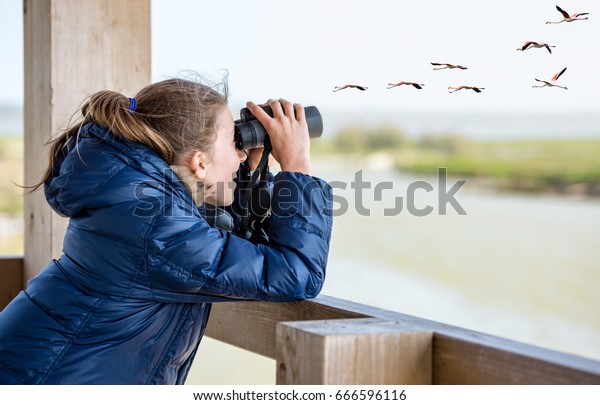 Young girl bird\
watching