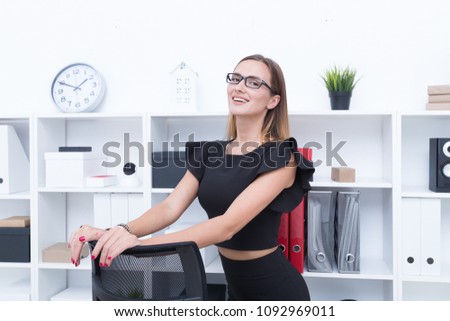 Young girl in black dress in the office
