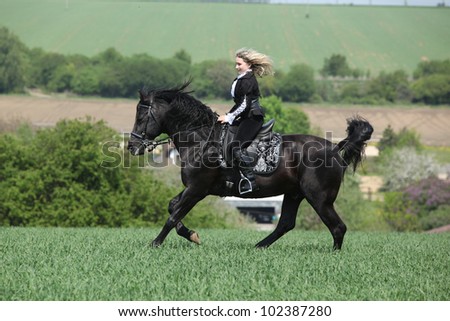 Young girl with black horse
