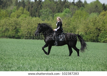 Young girl with black horse