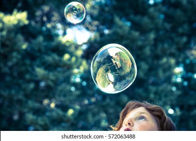 Young Girl Blowing Bubbles