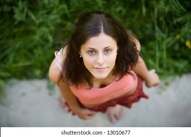 The young girl with blue eyes and dark hair looks in a shot, having lifted a head