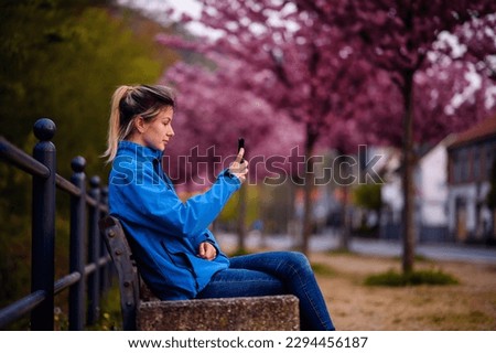 Similar – Image, Stock Photo Blonde woman looking at her smartphone outdoors