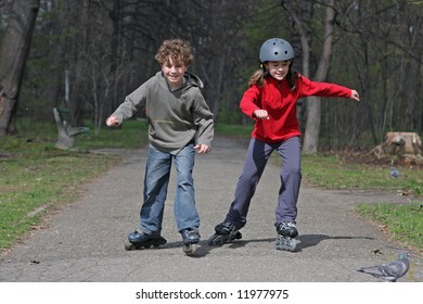 Young Girl And Boy On Roller Blades