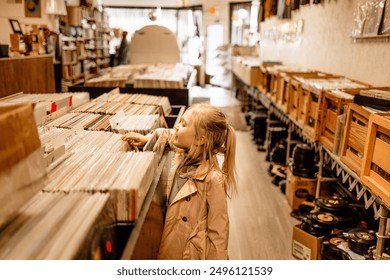 A young girl browses through vinyl records in a cozy record store, surrounded by shelves filled with music and a warm, nostalgic atmosphere. - Powered by Shutterstock