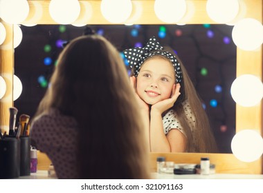 Young Girl With Brush Sitting Mear A Mirror.