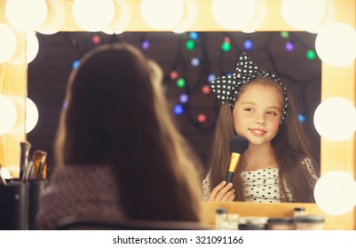 Young Girl With Brush Sitting Mear A Mirror.