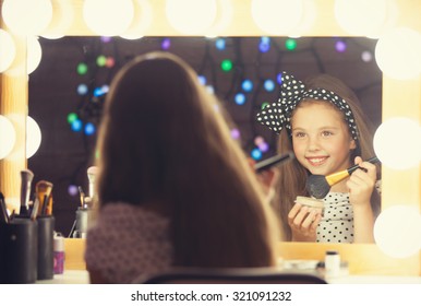 Young Girl With Brush Sitting Mear A Mirror.