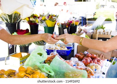 Young Girl Buying Fruit And Vegtables At A Market