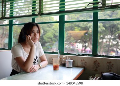 Young Girl Call Many Time, Waiting Someone Who Late And Find Him In Old Fashion Chinese Restaurant In Hong Kong