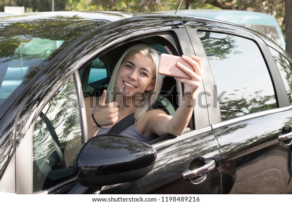 Young girl in the car\
with a mobile phone