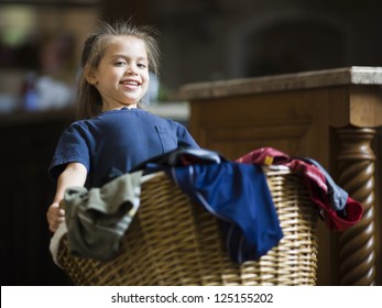 Young Girl Carrying Laundry Basket