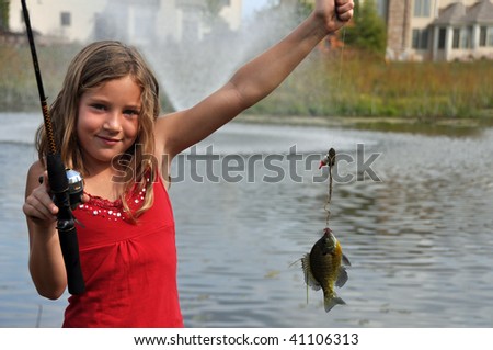 a young girl catches a fish