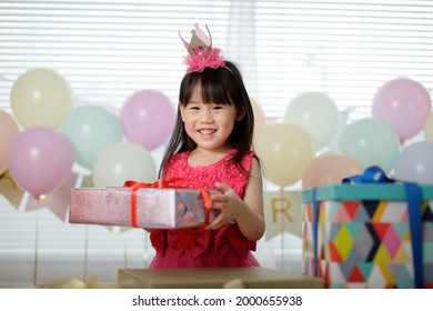 Young Girl Celebrating Her 5th  Birthday At Home 