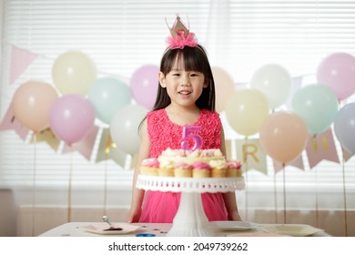 Young Girl Celebrating Her 5th  Birthday At Home 