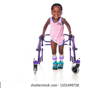 Young girl with cerebral palsy taking steps with her walker