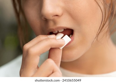 Young girl chews gum. Man face, opening mouth for chewing gum, mint taste, refreshing breathe. fresh breath. Bad breath. nicotine gum