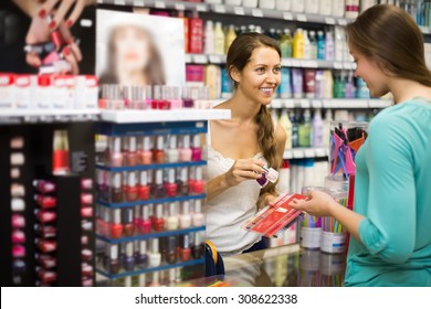 Young girl choosing new nail polish color at store