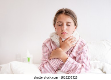 young girl with a cold sits in her bed