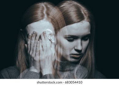 Young girl covering her face with her hands after reaching a peak of her depression - Shutterstock ID 683054410