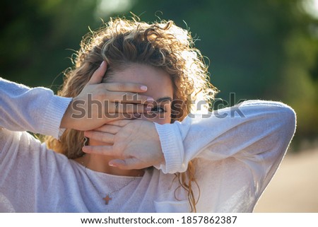 Similar – a desperate woman holding her hands in front of her face