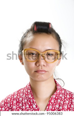 Young girl in curlers and large glasses to look like a studious nerd