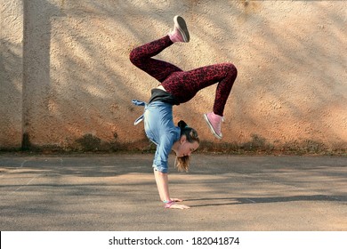 Young Girl Dancing Breakdance On The Street