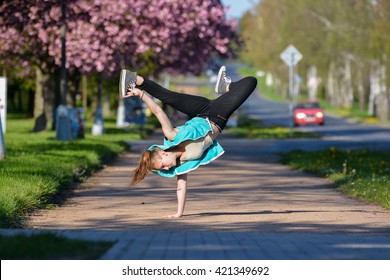 Young Girl Dancing Breakdance On The Street