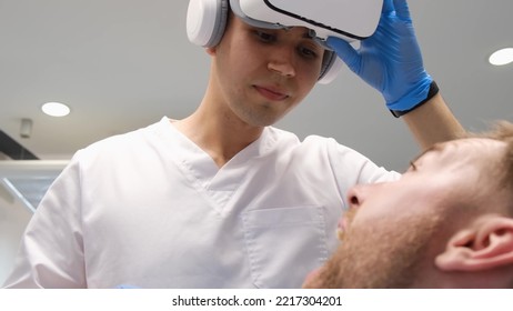 Young girl dentist treats teeth through virtual reality glasses - Powered by Shutterstock