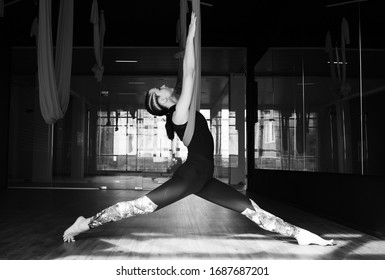 Young girl do fly yoga and stretches,yoga training, fly yoga, aerostretching, aerial yoga hammock,pilates therapy concept.