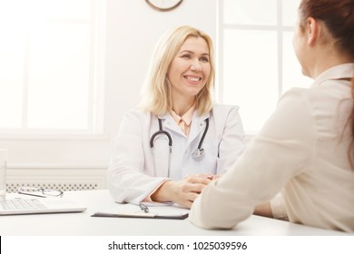 Young Girl At Doctors Appointment. Happy Female Doctor Telling Good News To Her Patient, Healthcare And Medical Concept, Copy Space