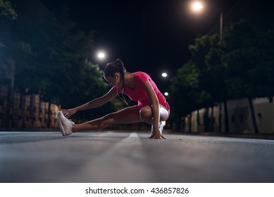 Young girl doing fitness outdoors at night. - Powered by Shutterstock