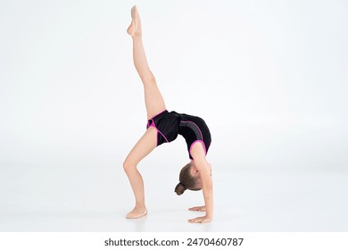 young girl doing gymnastics over white background - Powered by Shutterstock