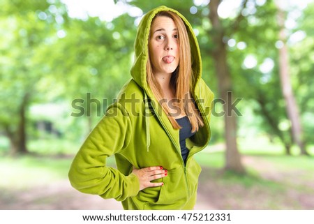 Young girl doing a joke on unfocused background