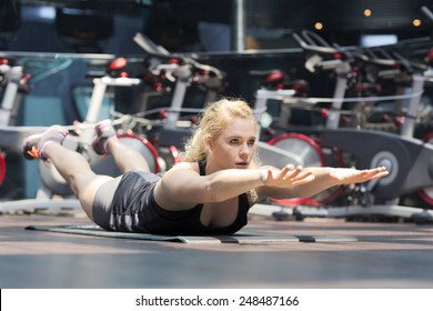 Young girl doing plank on her belly