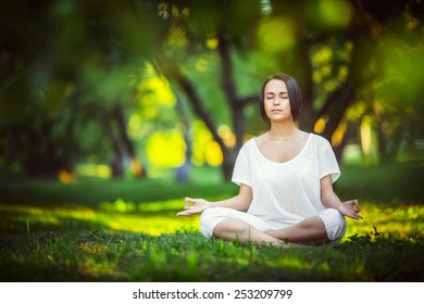 Young Girl Doing Yoga In The Park