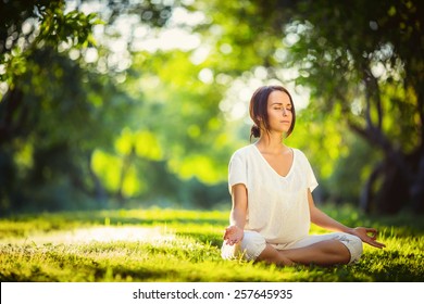 Young Girl Doing Yoga In The Park