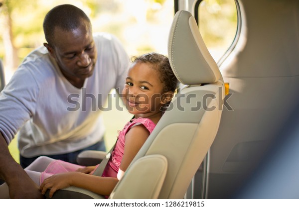 Young girl
dressed as a ballerina sitting in a
car.