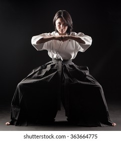 Young  girl dressed in hakama practicing Aikido