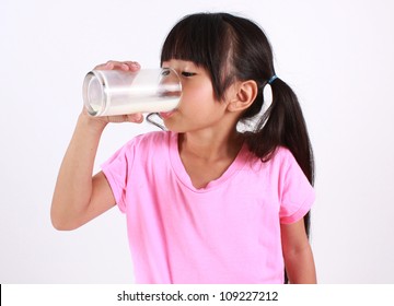 Young girl drinking milk.