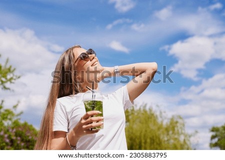 Similar – Image, Stock Photo Woman with sunglasses drinking green vegetable smoothie outdoors