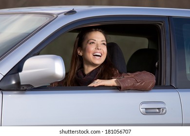 Young girl driving a car and looking through the window