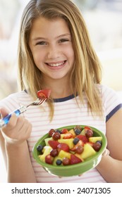 Young Girl Eating Fresh Fruit Salad