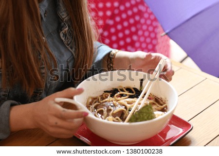 young girl eating japanese food Ramen