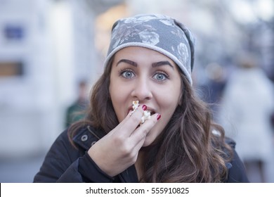 Young Girl Eating Popcorn While Walking Down The Street. Portrait
Shallow Depth Of Field