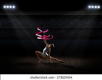 Young girl engaged art gymnastic at sports hall - Powered by Shutterstock